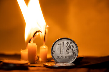 Russian rubles near the candle flame. Financial sanctions against Russia. Russian economy and...