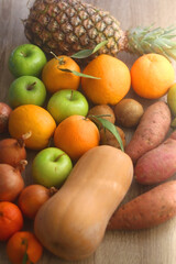 Various healthy fruit and vegetable on wooden background. Selective focus.