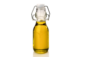 Extra virgin olive oil in small bottle with hermetic mechanical cap isolated on white, clipping path