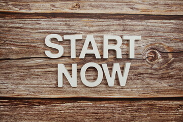 Start Now Word alphabet letters on wooden background