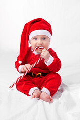The biggest gift of all. Studio shot of a little boy dressed up in a santa costume.