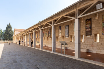 Fototapeta premium Icons donated to the church from different countries depicting the Virgin Mary and the baby in her arms hang on the walls in the courtyard of the Church Of Annunciation in Nazareth, northern Israel