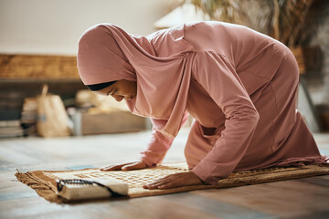 Religious Black Muslim woman praying namaz at home.