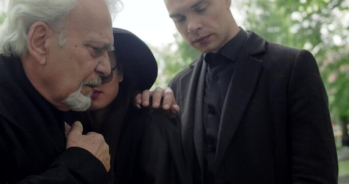 Relatives grives at the funeral at local cemetery, funeral and farewell, honoring the passed relatives, 4k 60p Prores