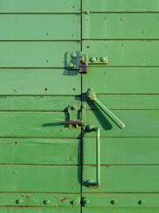Green vintage train carriage door closure, lock.