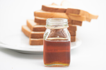 Six slices of bread with honey and honey dipper isolated on white studio background