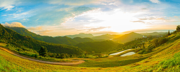 Fototapeta na wymiar Beautiful panoramic views of mountains and sky.,Panorama of the Romanian countryside at sunset in the evening light. wonderful spring landscape in the mountains meadows and rolling hills, 