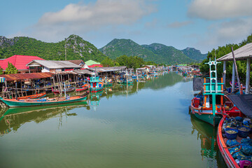 Fototapeta na wymiar fisherman village scenery in asia,Fisherman Boat with sunset sky in fishing village
