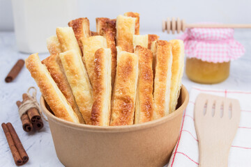 Delicious and sweet puff pastry sticks with cinnamon