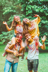 young happy friends at holi fest