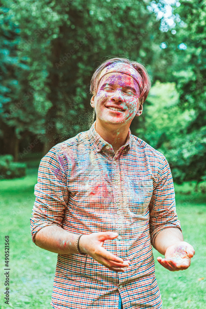 Canvas Prints portrait of young happy man dirt in holi paints