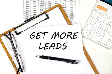 Text GET MORE LEADS on the white paper on clipboard with chart and calculator