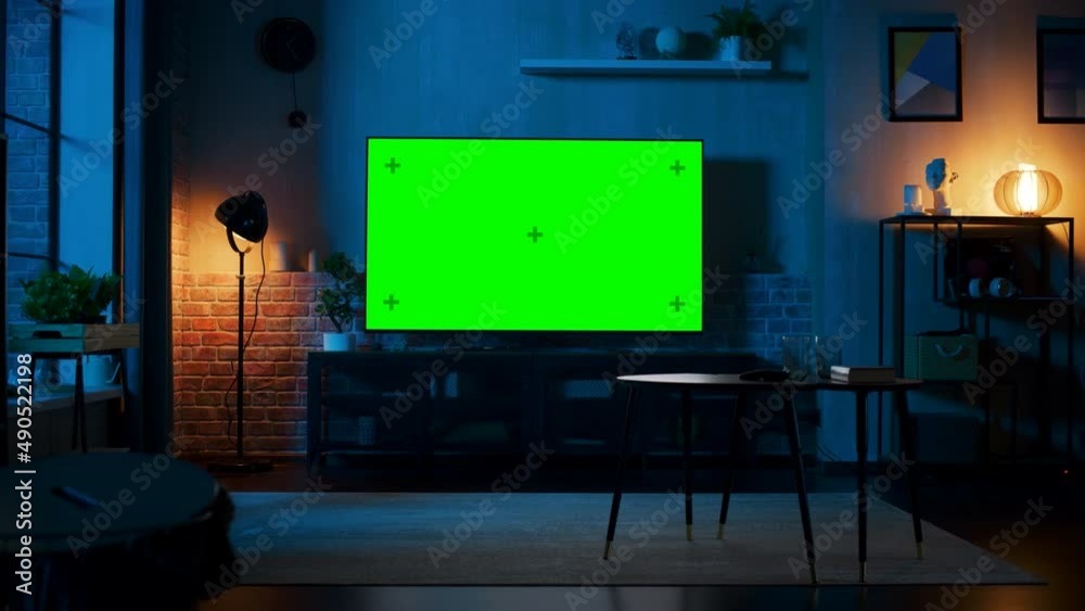 Poster stylish loft apartment interior with tv set with green screen mock up display standing on television