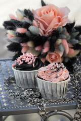 Grunge style cupcakes with black and pink cream