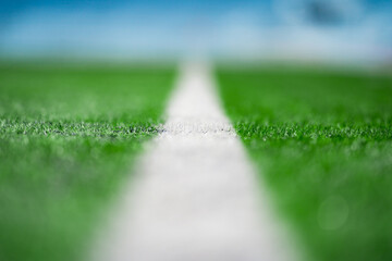 Close up to the White Touch Line of Green Artificial Grass Turf Outdoor on green soccer field. - obrazy, fototapety, plakaty