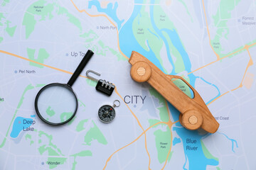 Travel items and wooden car on map