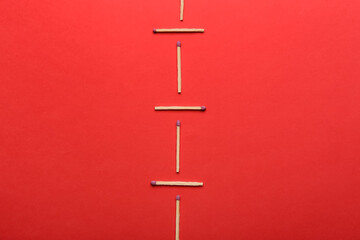 Whole matchsticks on red background. Social distancing concept