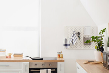 Stylish counters and pegboard in kitchen interior