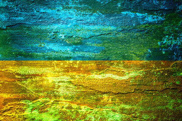 An old image of the flag of Ukraine on a wall with a crack. A crisis.