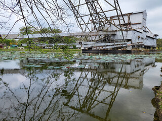 Old tin mining dredge in Tanjung Tualang, Perak, Malaysia, restored into exhibition building for visitors to learn about tin mining history and process in country.