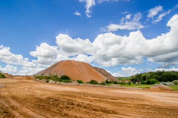 A large pile of sand was piled up in the sun and rain for many years.