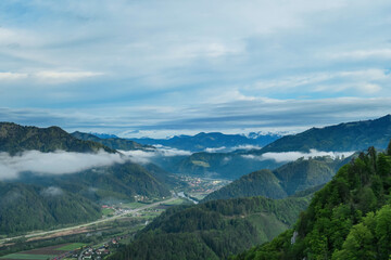 Panoramic view on the Eisenerzer Alps from below mount Roethelstein near Mixnitz in Styria, Austria. Snow capped mountain of the Ennstal Alps beyond the Grazer Bergland in Styria, Austria. Village