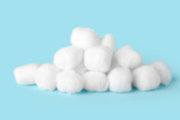 Heap of cotton balls on color background
