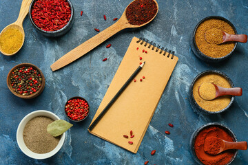 Composition with notebook and aromatic spices on color background