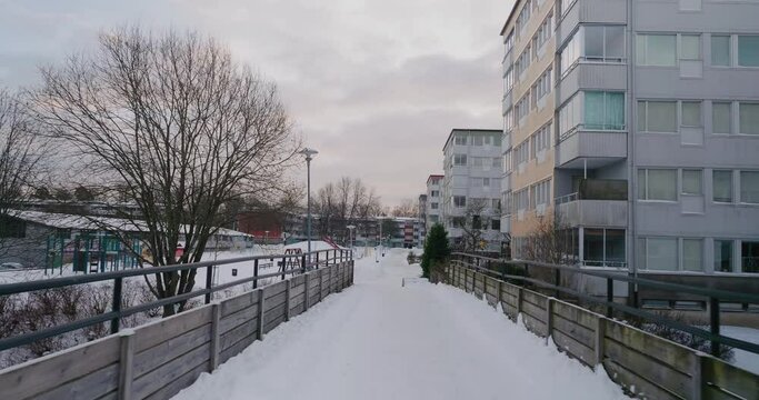 POV Walking Accross a Bridge in an Apartment Building Neighbourhood in Winter, Bor&aring;s Sweden - Wide Shot Tracking Forward