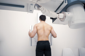 patient in an x-ray room. X-ray of the human back. Classic ceiling mounted X-ray system. Medical equipment