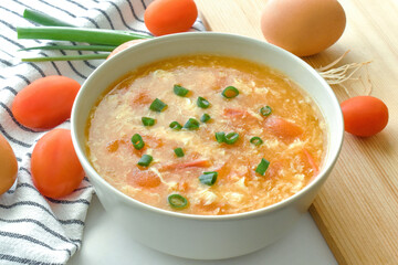 Tomato egg drop soup in a white bowl. Traditional Chinese food. 