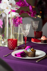 Pink and purple decoration and cupcakes on the table