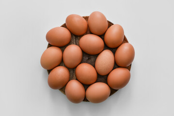 Plate with fresh chicken eggs on light background