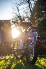 Moped from behind at sunset