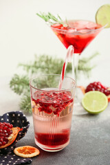 Glasses of tasty pomegranate cocktail on table