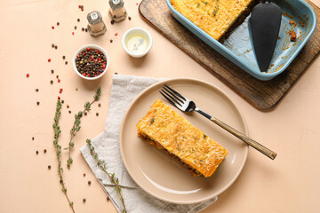 Plate with piece of tasty Shepherd's pie on beige background