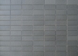 Gray natural stone tiles for modern ventilated building facade or walls. Background and texture.
