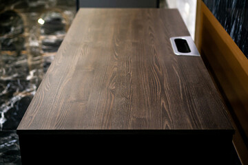 Empty rough wooden table top in the dark room