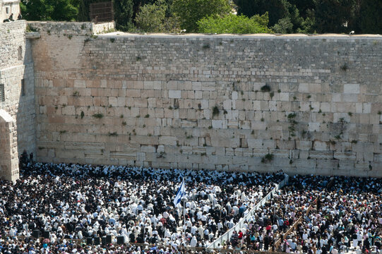 Jewish worshippers crowd into the prayer section below the Western Wall in Jerusalem for the Blessing of the Cohanim or priests given twice each year on the holidays of Passover and Sukkot.
