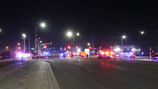 Police, fire truck and ambulance emergency lights flashing on street intersection