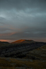 The first rays of light appearing in a cloudy morning