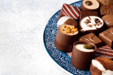 Various chocolate praline candies assortment close up