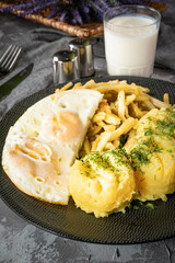 Fried eggs with boiled potatoes and yellow string beans. Tasty meal.
