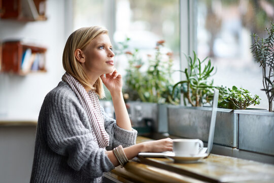 We all need somewhere to go to be alone. A young woman sitting in a coffee shop.
