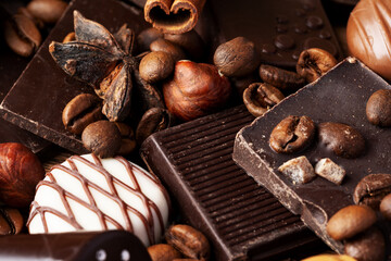 chocolate, cocoa, nuts and spices on wooden background