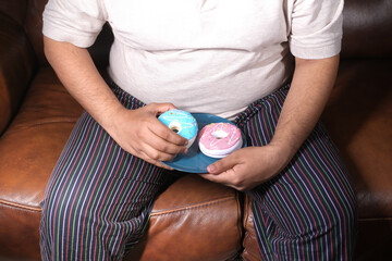 Fototapeta premium young man eating donut , selective focus 