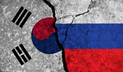 Political relationship between South Korea and russia. National flags on cracked concrete background