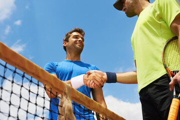 Their friends and great rivals on the court. Two male tennis players on the court.