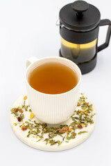 Obraz na płótnie Canvas Relax herbal tea on a white background. Herbal tea prepared with lemon balm leaves, jasmine flower, apple peel, orange, lemon and hibiscus particles.
