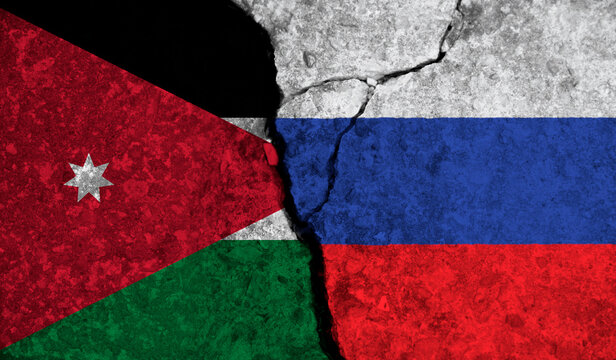Political relationship between Jordan and russia. National flags on cracked concrete background